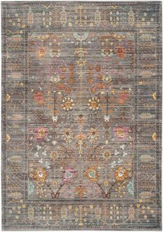 an area rug with various colors and designs on the carpet, including greys, oranges, yellows, and pinks