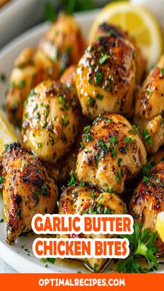 garlic butter chicken bites on a plate with lemon wedges