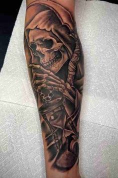 a man's arm with a skull and cross on it