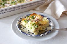 a blue and white plate topped with food next to a casserole dish