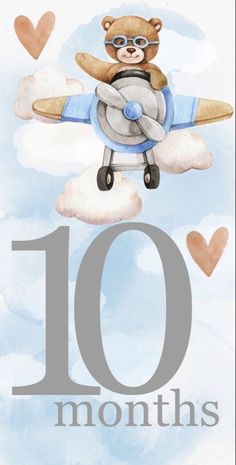 an airplane with the number ten on it is flying through the sky and has hearts