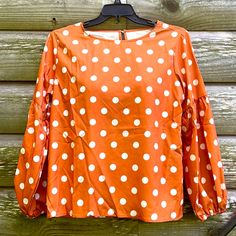 Adorable Mustard/Gold Color Polka Dot Blouse That Has Never Been Worn. It Was Only Taken Out Of The Packaging To Be Tried On. It Is Very Stylish With A Round Neck And Back Button Enclosure. The Balloon Sleeves Are Very Flattering And Have Elastic At The Wrist. Made Of 95% Polyester And 5% Spandex. Measurements Are: Pit To Pit - 22”, Shoulder To Hem - 26.5”, Sleeve Seam To Wrist - 24”. Of Course No Rips Or Stains And Comes From A Smoke Free Home. Polka Dot Long Sleeve Blouse For Brunch, Long Sleeve Polka-dot Blouse For Brunch, Long Sleeve Polka Dot Blouse For Brunch, Polka Dot Blouse, The Balloon, Balloon Sleeves, Orange White, Gold Color, Mustard