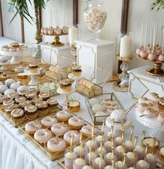 a table filled with lots of desserts and cupcakes on top of it