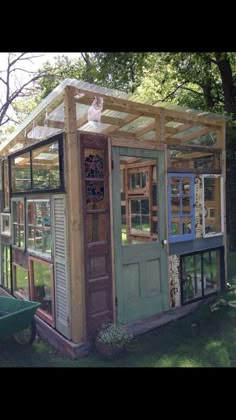 a small wooden structure with windows and doors