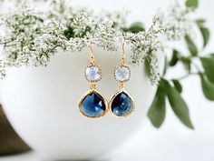 "These stunning Sapphire Earrings are the perfect addition to any jewelry collection. Handmade with care Classy blue color Dangle style with gold accents. Suitable for any occasion, including weddings and bridesmaid gifts. Their classic design is sure to make a statement and elevate any outfit. They are carefully crafted with attention to detail, making them a unique and special addition to your jewelry collection. The beautiful blue color of these earrings is truly captivating. The gold accents add an extra touch of elegance, making these earrings perfect for special occasions or everyday wear. If you're looking for a one-of-a-kind gift, then look no further. Whether you're shopping for yourself or someone special in your life, these Sapphire Earrings are sure to impress! Color = Light Sa Blue Teardrop Earrings For Anniversary, Blue Dangle Teardrop Earrings For Anniversary, Blue Teardrop Bridal Earrings For Anniversary, Blue Dangle Bridal Earrings Gift, Elegant Blue Crystal Earrings For Gift, Blue Dangle Earrings For Bridesmaids, Blue Drop Earrings For Anniversary, Blue Jewelry With Matching Earrings For Bridesmaid Gift, Blue Drop Earrings For Bridal Gift