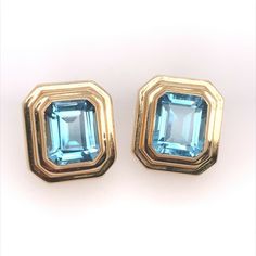 "Retro 14k Gold Natural Emerald Cut Blue Topaz Earrings Circa 1970.  Each stone measures approximately 12x9.5x6.5mm. Total weight is approximately 12 carat, actual weight of the earrings is 7.2 grams. Condition is \"Pre-owned\". Shipped with USPS First Class." Classic Gemstone Clip-on Earrings For Anniversary, Luxury Topaz Earrings For Formal Occasions, Formal Yellow Gold Topaz Earrings, Classic Blue Hallmarked Earrings, Formal Topaz Earrings, Classic Yellow Gold Blue Topaz Earrings, Classic Blue Topaz Gemstone Earrings, Classic Gold Earrings With Blue Topaz, Classic Blue Topaz Yellow Gold Earrings