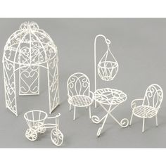 miniature white garden furniture set on grey background