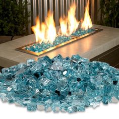 an outdoor fire pit with blue glass blocks