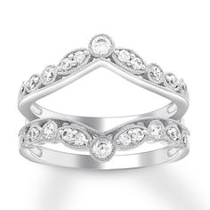 a white gold ring with diamonds in the shape of a triangle and an open diamond band