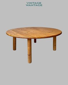 an oval wooden table with two legs and a round top, made out of wood