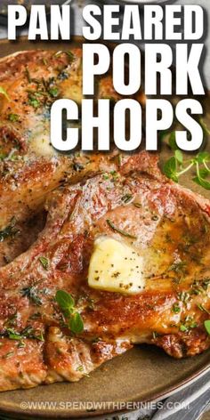 pan seared pork chops on a plate with herbs