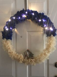 a wreath decorated with blue and white lights