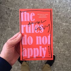 a person holding up a book that says the rulesy do not apply