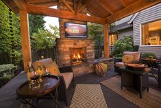 an outdoor living area with fireplace and seating