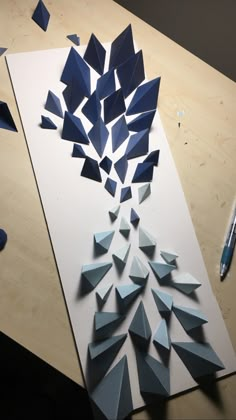 a piece of paper that has been cut into shapes and placed on top of a table