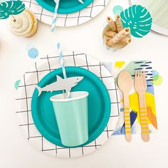 a table set with plates, cups and utensils for children's birthday party