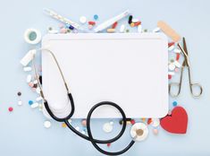 a white board surrounded by medical supplies on a blue background with confetti and scissors