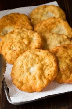 some biscuits are sitting on a napkin next to a knife