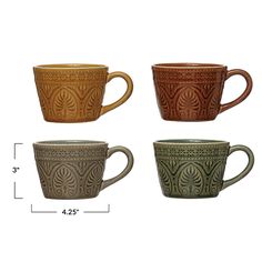 four different colored coffee mugs sitting next to each other