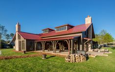 a large house with a red roof in the grass