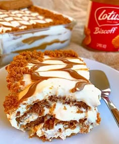 a piece of cake sitting on top of a white plate next to a container of ice cream