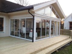 a house with a deck and glass doors on it