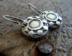 "\"Concho\" - I created these by taking a mold of one of the conchos on my saddle & casting it in silver.. perfect for the horse lover or western enthusiast! COMPONENTS/PROCESS: ~15mm cast replicas of one of my saddle conchos hand crafted of recycled fine silver (99% pure silver/sterling is 92.5% silver). As I construct each one entirely by hand sizes are approximate. My hand crafted sterling silver earwires. All given an oxidized polished finish. LENGTH: Including my handforged earwires is Handmade Small Sterling Silver Earrings, Rustic Sterling Silver Dangle Jewelry, Artisan Oxidized Finish Earrings For Everyday, Handmade Antique Silver Round Earrings, Silver Stamped Earrings For Everyday, Everyday Silver Stamped Earrings, Small Handmade Sterling Silver Earrings, Adjustable Stamped Dangle Earrings, Rustic Sterling Silver Earrings