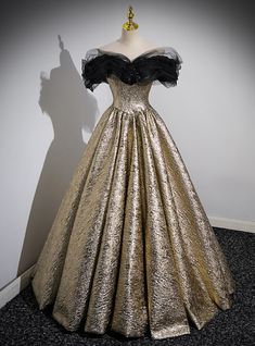 Command the room with celestial elegance in this golden prom dress, designed to make you the star of the evening. With its metallic sheen, the gown evokes the glamorous aura of a moonlit gala. This creation features a full, pleated ballgown skirt that fans out like rays of golden sunshine. Its corseted bodice is meticulously fitted to flatter your figure, while the off-the-shoulder tulle sleeves add a dreamy touch with their sheer, billowy design. At the heart of the bodice, a cluster of dark ro Black Dress Long Classy, Satin Quinceanera Dress, Dress Long Classy, Golden Prom Dress, Prom Dress Gold, Bridesmaid Dresses Dusty Sage, Flower Prom Dress, Black Dress Long, Black And Gold Dress