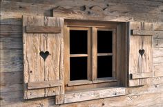 an old wooden window with hearts on it