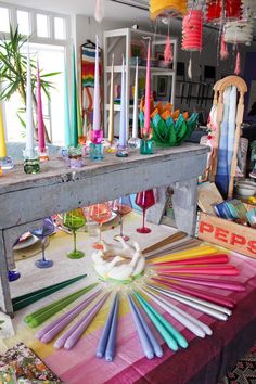 a table with many different colored candles on it