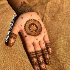 a woman's hand with henna tattoos on it