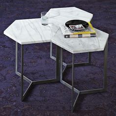 two tables with marble top and metal legs on purple carpeted flooring in living room