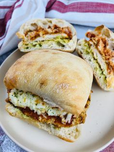 a sandwich cut in half sitting on top of a white plate