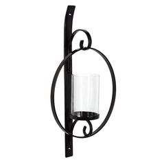 an iron candle holder with a glass on the front and back of it's holder