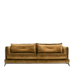 a brown couch sitting on top of a white floor