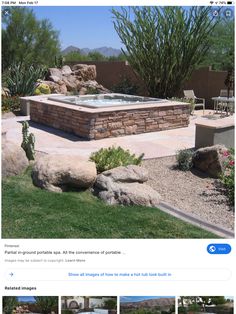 an outdoor hot tub surrounded by rocks and cactuses in a backyard with landscaping around it