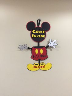 a mickey mouse clock hanging on the wall