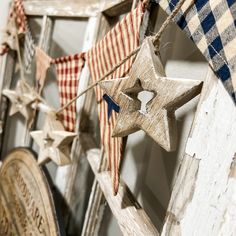 several wooden stars are hanging on a wall next to a clock and other decorative items