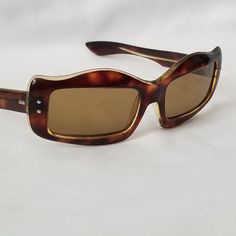 "Vintage French Amber Tortoise Rectangle Cat Eye Sunglasses SG9/INV THESE ARE NON PRESCRIPTION READY TO WEAR MORE EYEWEAR LISTED Such a cool look. Rectangle lenses with cateye style frame. Frames are a layered, amber tortoise over a clear acetate. Which gives them a dimensional look. Frames have been polished up, there is one small scratch on the left temple/arm from being folding closed. Lenses are in very good condition, no scratches or rub marks. These will be shipped with a vintage case. THE Vintage Tortoiseshell Sunglasses, Vintage Acetate Sunglasses With Mirrored Lenses, Vintage Tortoiseshell Sunglasses With Gradient Lenses, Vintage Rectangular Glass Sunglasses, Vintage Tortoiseshell Wayfarer Sunglasses, Vintage Rectangular Sunglasses For Formal Occasions, Vintage Rectangular Sunglasses For Formal Events, Vintage Brown Rectangular Sunglasses, Vintage Tortoiseshell Rectangular Sunglasses