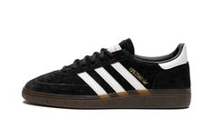 The adidas Handball Spezial “Black/White” is a versatile colorway of the retro shoe with a classic black and white color block.  The construction features a black suede upper and white leather Three Stripes and gold “Spezial” branding on the side.  The leather heel tab, as well as the “adidas Handball Spezial” branding on the tongue are accented in white.  A dark gum rubber sole completes the look. Dark Gums, Spezial Shoes, Adidas Handball Spezial, Adidas Handball, Shoe Wishlist, Plus Size Bodycon Dresses, Adidas Spezial, Stadium Goods, Retro Shoes