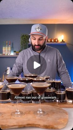 a man sitting at a table with several glasses on it and the words almost ran out of glassware