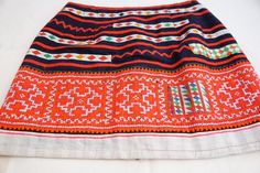 Ladies small boho Thai hill Tribe textile ethinc mini skirt.Handmade and one-of-a-kind.This amazing skirt is made with a dark blue cotton Thai textile, with colorful cotton patchwork pieces hand stitched in.The bottom half of the skirt is a vibrant pink and orange/red, hand stitch Hmong Hill Tribe textile fabric.This skirt is a size small.Measuring approximately 13 inches long.Waist measures approximately 26 inches wide.Hips measures 35 inches wide.There is a soft black polyester inner slip laye Bohemian Cotton Mini Skirt, Traditional Embroidered Mini Skirt, Traditional Mini Skirt With Lining, Traditional Mini Skirt For Festival, Bohemian Lined Mini Skirt For Festival, Bohemian Embroidered Mini Skirt, Summer Bohemian Skirt With Traditional Patterns, Bohemian Multicolor Skirt With Traditional Patterns, Traditional Cotton Mini Skirt