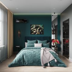 a bedroom with teal colored walls and bedding in the center, along with a painting on the wall