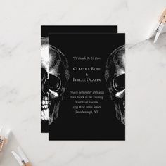 a black and white wedding card with two skulls on the front, one skull in the back