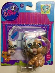 the littlest pet shop has two small dogs in it's plastic packaging, one is