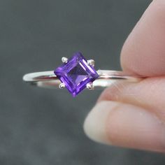 This ring is made from beautiful purple Amethyst which has beautiful violet hues. It is size 7. The color purple is traditionally the color of royalty and amethyst has been used since the dawn of history to adorn the rich and powerful monarchs and rulers. Fine amethysts are featured in the British Crown Jewels and were also a favorite of Catherine the Great and Egyptian royalty. The princess cut faceted gemstone is 5 mm and is prong set in sterling silver.  Your sterling silver ring will be ship Purple Sterling Silver Promise Ring, Lavender Amethyst Solitaire Ring As A Gift, Purple Amethyst Promise Ring With Vs Clarity, Lavender Amethyst Ring With Birthstone, Formal Purple Amethyst Birthstone Ring, Fine Jewelry Amethyst Ring In Sterling Silver, Purple Amethyst Sterling Silver Ring, Purple Amethyst Ring With Prong Setting As Gift, Solitaire Amethyst Ring In Fine Jewelry Style