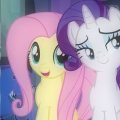 two little ponys standing next to each other