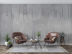 two chairs and a table in front of a gray wall with circles on the walls