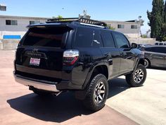 a black suv parked in a parking lot