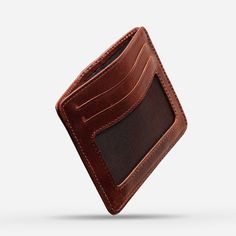 With this handmade leather card holder, you can upgrade your wallet game. This stylish and functional handmade wallet features rich, full-grain leather construction. This wallet can hold 6-9 cards, has 2 ID windows, and has a secret cash compartment. It offers ample space for all your essentials. Its magnetic closure makes it secure and easy to access. Its slim design fits perfectly into any pocket or bag, making it easy to carry. It makes the perfect gift, packaged in a premium gift box. Invest Leather Trifold Wallet With Card Slots For Everyday, Everyday Carry Leather Card Holder With Smooth Grain, Leather Card Holder For Everyday Carry, Leather Rectangular Card Holder With Coin Pocket, Bifold Card Holder With Leather Patch For Everyday Use, Bifold Leather Patch Card Holder For Everyday Use, Leather Rectangular Card Holder For Everyday Carry, Leather Rfid Blocking Card Holder For Everyday, Leather Card Holder With Card Slots For Everyday